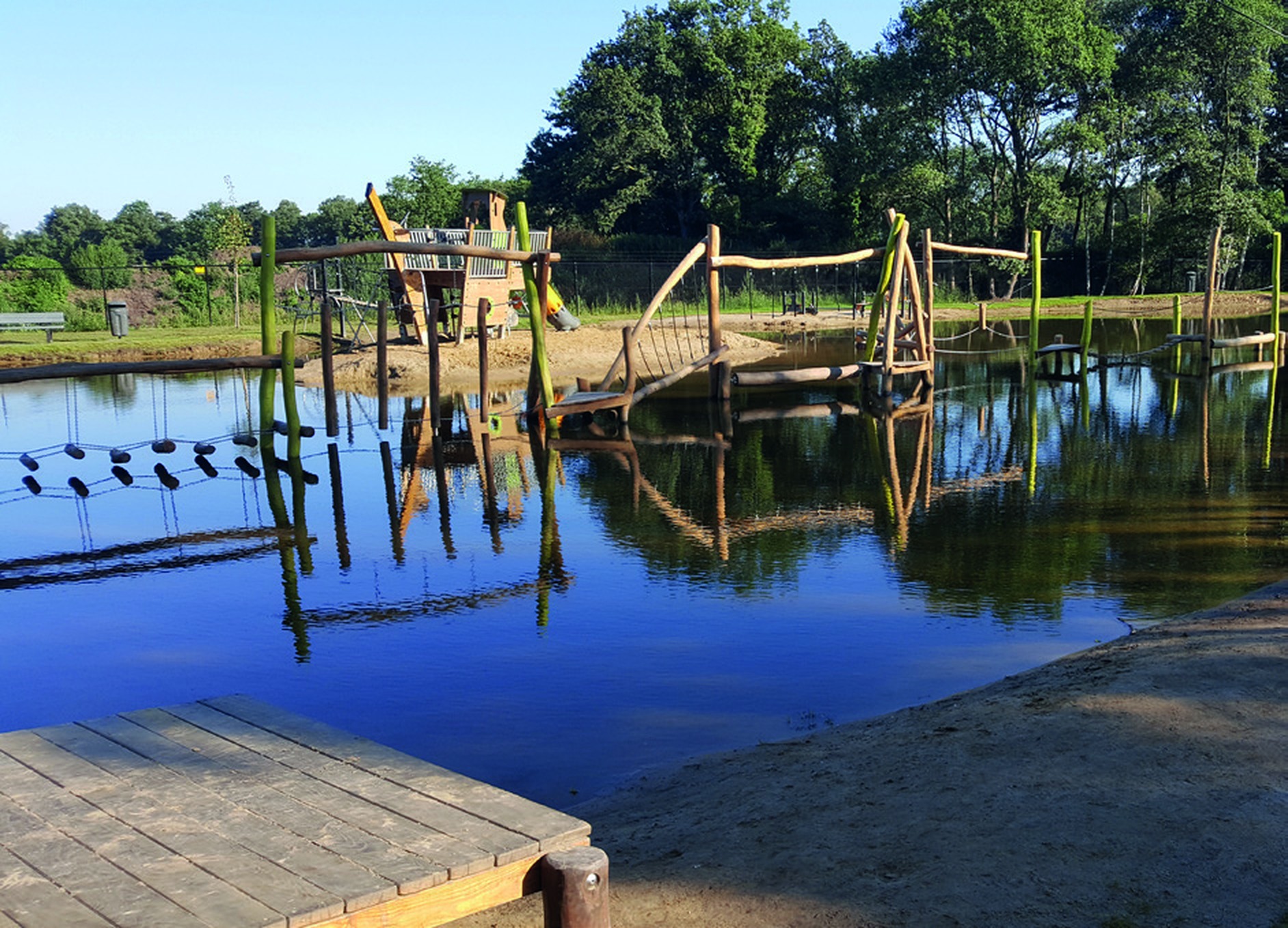 Large ECOLAN natural swimming pond with timber play structures